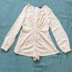 Cream long sleeved romper.